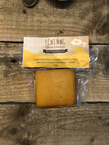 Smoked Welsh Cheddar cheese offers a delightful combination of the beloved Cheddar characteristics with a smoky twist, creating a unique and flavoursome cheese experience