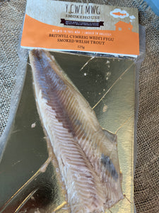 Y Cwt Mwg Anglesey Smoked trout has a delicate yet distinct taste that combines the natural flavors of the fish with the smoky aroma imparted during the smoking process.